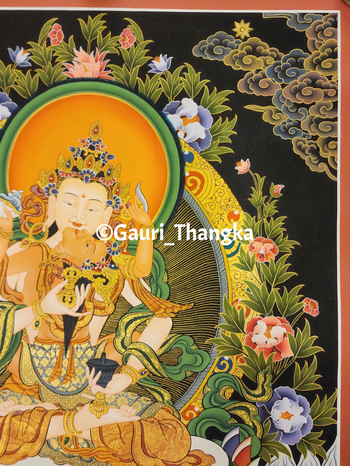 Colorful thangka of a deity with intricate details and floral elements.